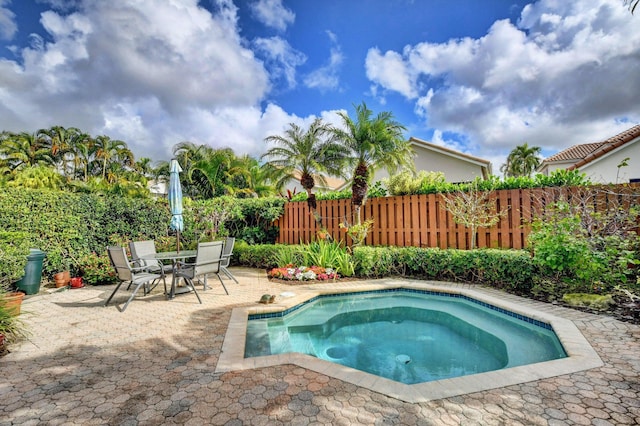 view of pool with an in ground hot tub and a patio