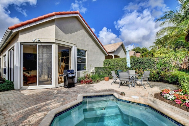 rear view of property featuring a patio area