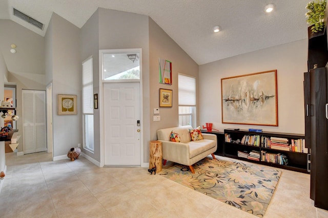 tiled entryway with high vaulted ceiling