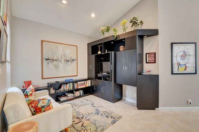 living room with light tile patterned floors and vaulted ceiling