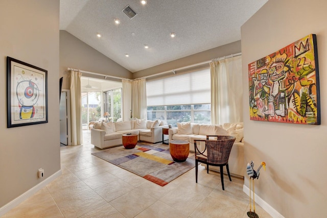 tiled living room with high vaulted ceiling and a textured ceiling