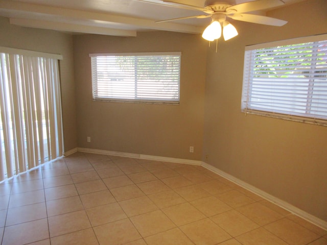 tiled spare room with ceiling fan