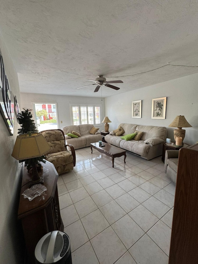 tiled living room featuring ceiling fan and a textured ceiling