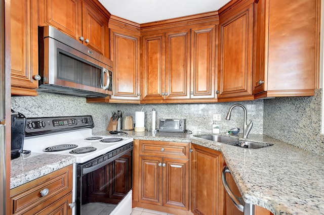 kitchen featuring electric stove, light stone countertops, sink, and tasteful backsplash