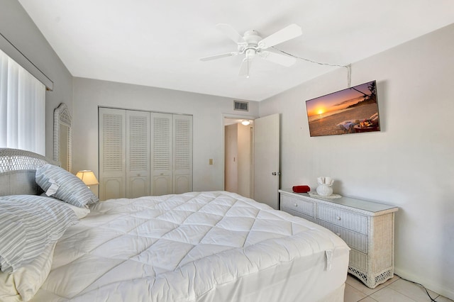 tiled bedroom featuring a closet and ceiling fan