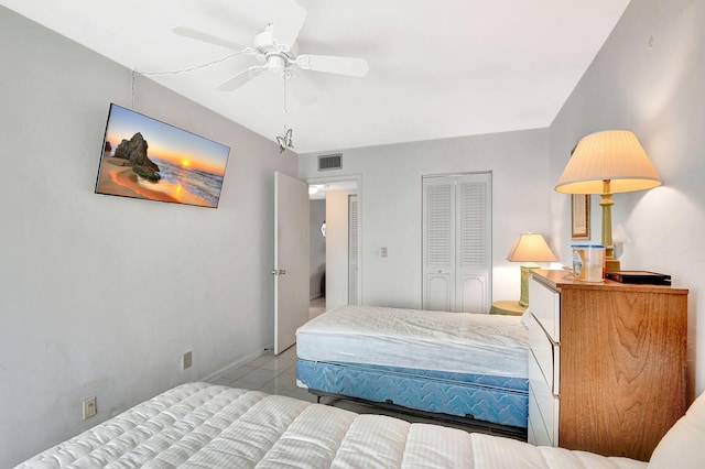 bedroom with ceiling fan, a closet, and light tile patterned floors