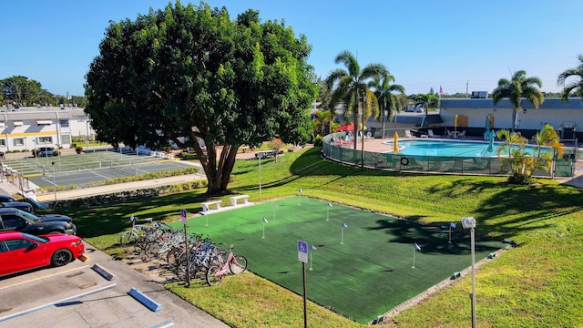 surrounding community featuring a pool and a lawn