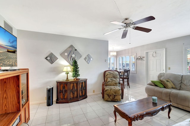 living room with ceiling fan and light tile patterned floors