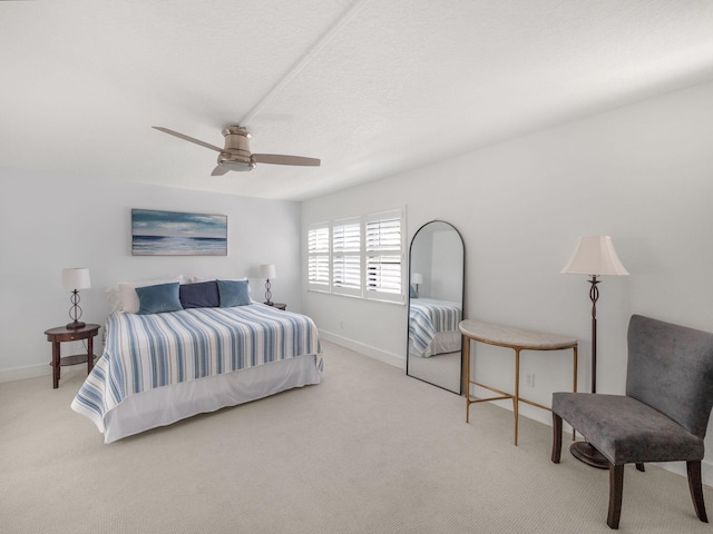 carpeted bedroom featuring a textured ceiling and ceiling fan