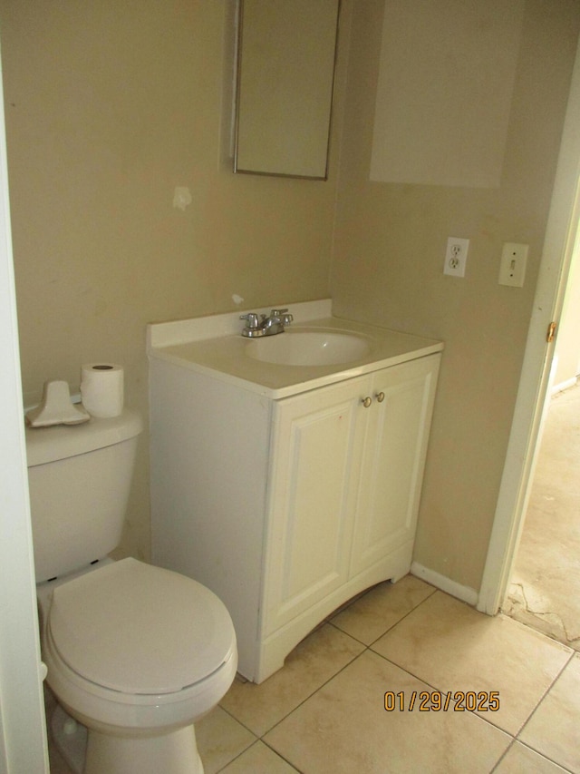 bathroom with vanity, tile patterned flooring, and toilet