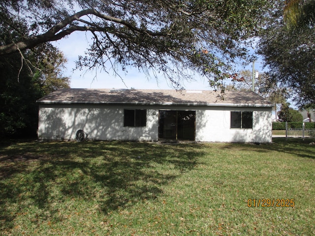 rear view of property with a yard