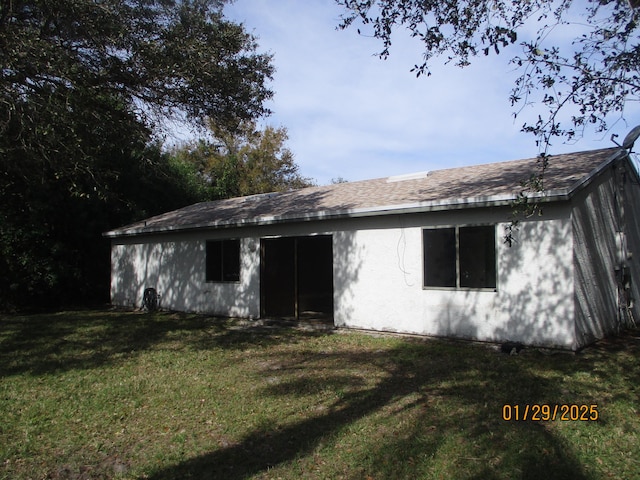 back of house with a yard