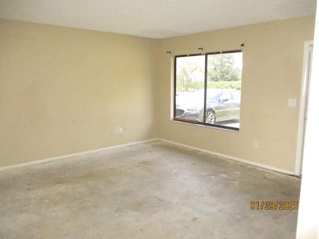 unfurnished room featuring concrete floors