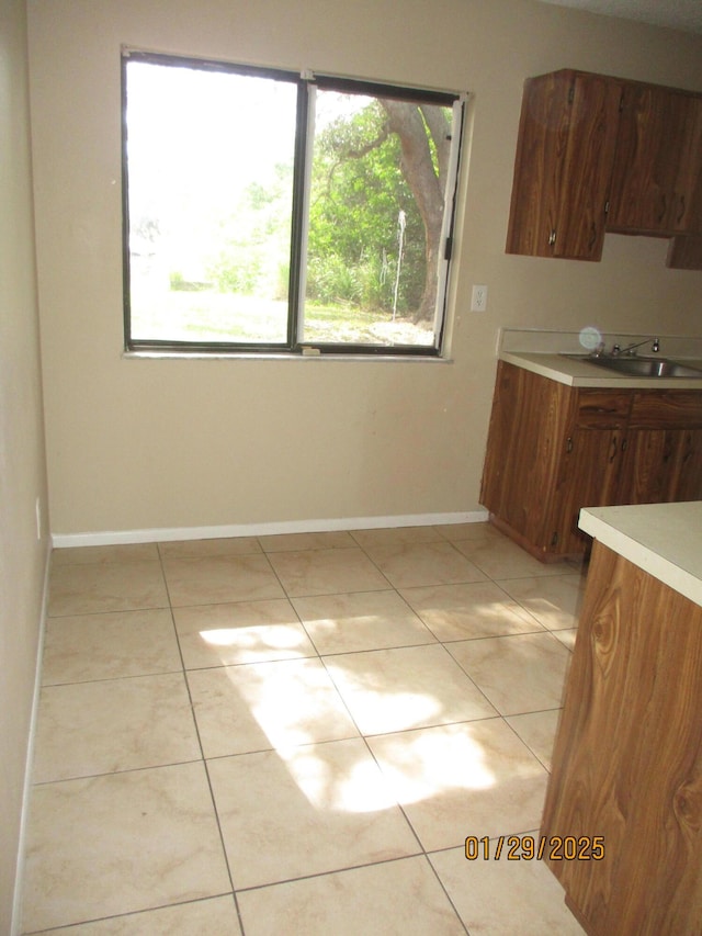 interior space with sink and light tile patterned floors