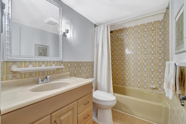 full bathroom with shower / bathtub combination with curtain, vanity, toilet, and tile walls