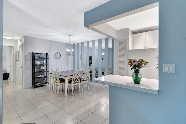 tiled dining area with an inviting chandelier