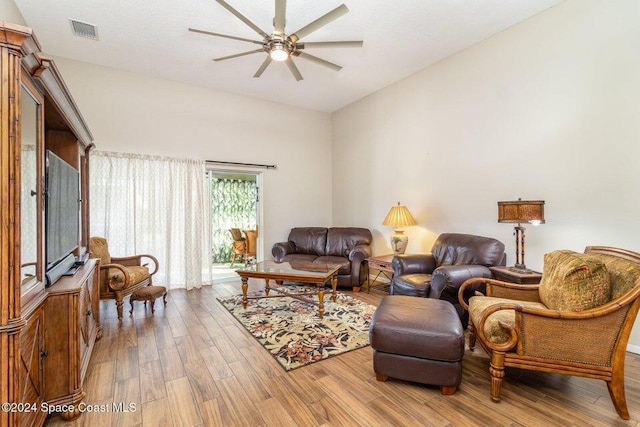 living room with hardwood / wood-style flooring and ceiling fan