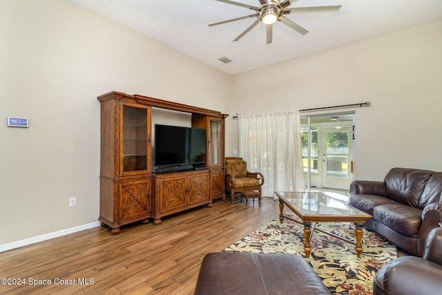 living room with ceiling fan and light wood-type flooring