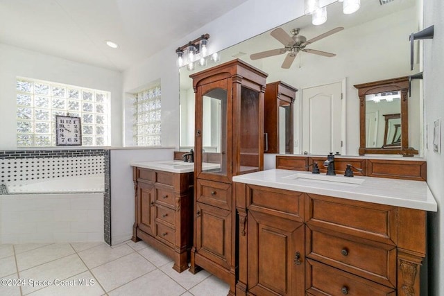 bathroom featuring a relaxing tiled tub, vanity, tile patterned flooring, and ceiling fan