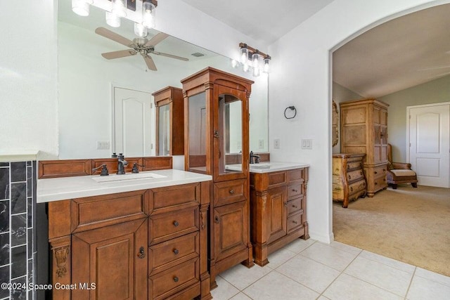 bathroom featuring tile patterned flooring, vanity, vaulted ceiling, and ceiling fan