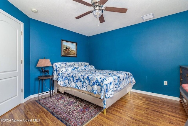 bedroom featuring wood-type flooring and ceiling fan