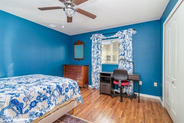 bedroom with a closet, ceiling fan, and light hardwood / wood-style flooring