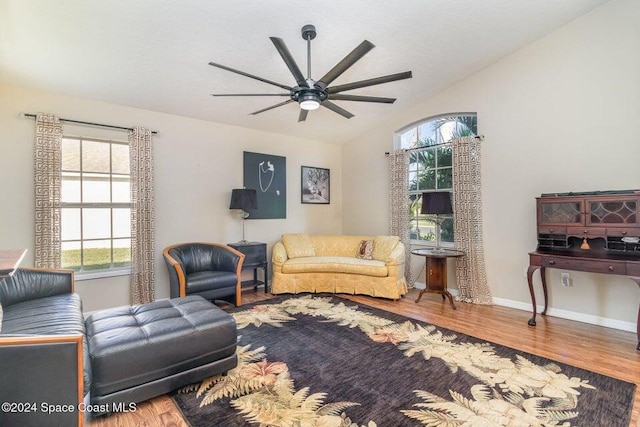 living room with lofted ceiling, hardwood / wood-style flooring, and a wealth of natural light