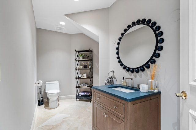 bathroom featuring vanity and toilet