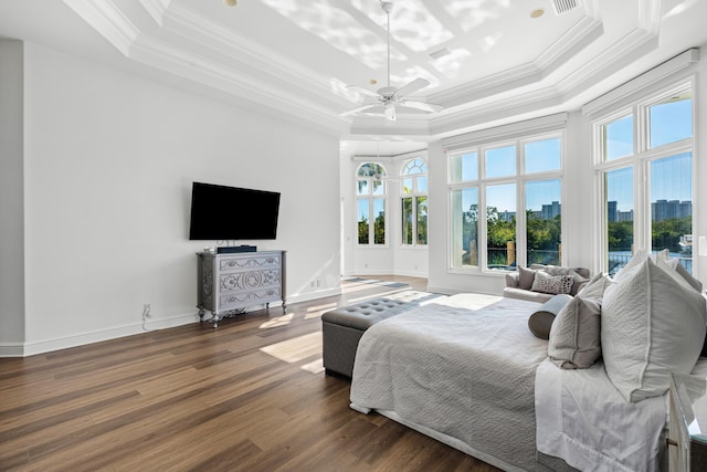 bedroom with crown molding, ceiling fan, dark hardwood / wood-style floors, and a raised ceiling