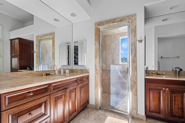 bathroom featuring vanity and a shower with shower door