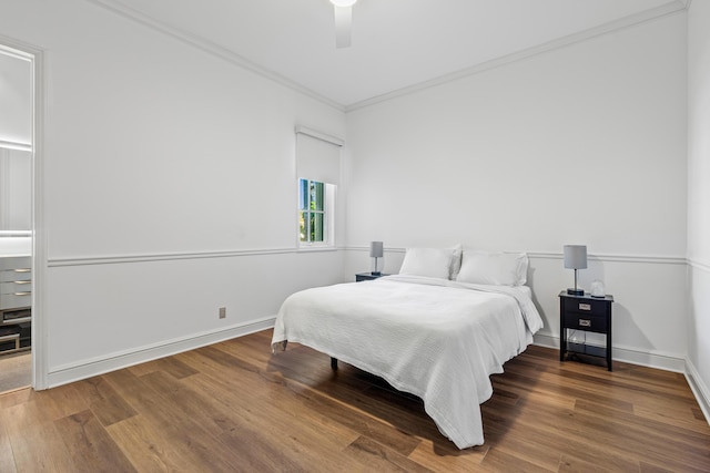 bedroom featuring ornamental molding, wood-type flooring, and ceiling fan