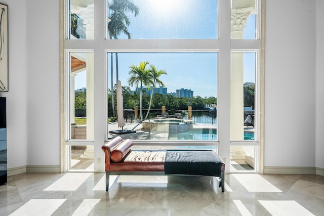 doorway featuring a water view and a high ceiling