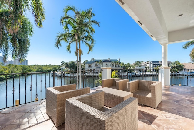 view of patio with a water view and outdoor lounge area