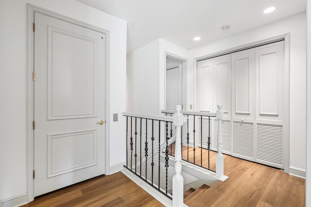 corridor with hardwood / wood-style flooring