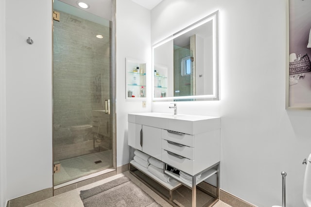 bathroom with vanity, tile patterned floors, and a shower with door