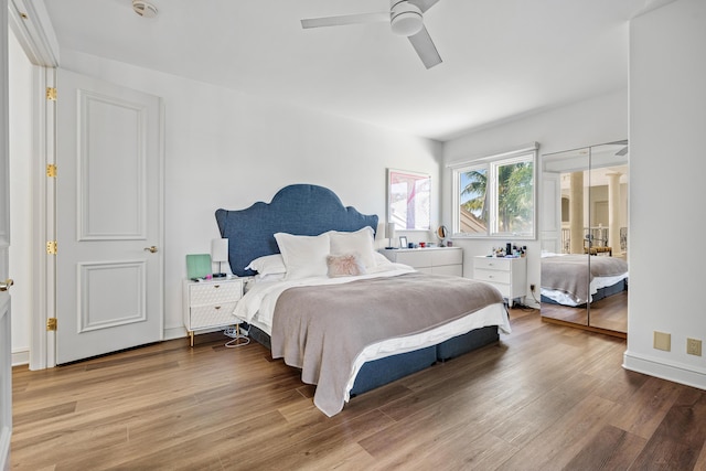 bedroom with hardwood / wood-style floors and ceiling fan