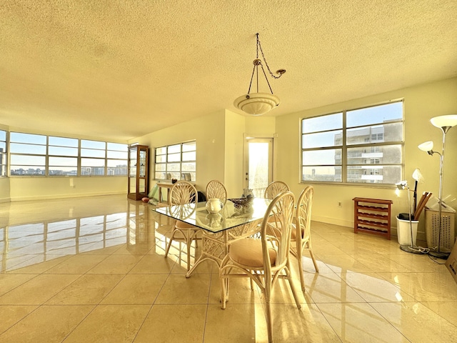 dining room with light tile patterned floors and a textured ceiling