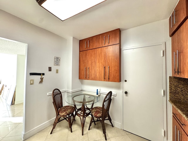 dining area featuring light tile patterned flooring