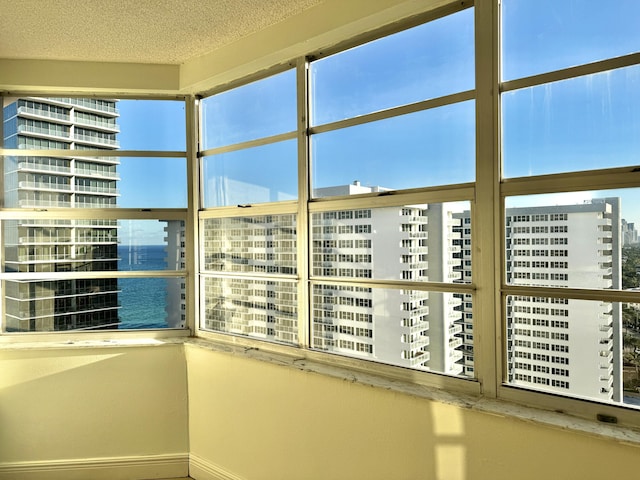 details featuring a textured ceiling and a water view