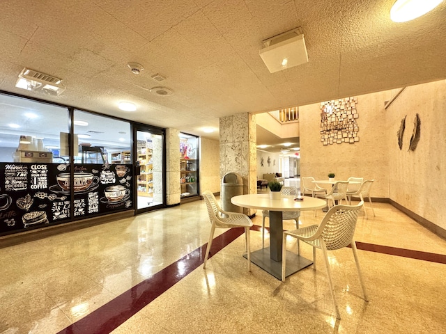 dining space featuring a textured ceiling