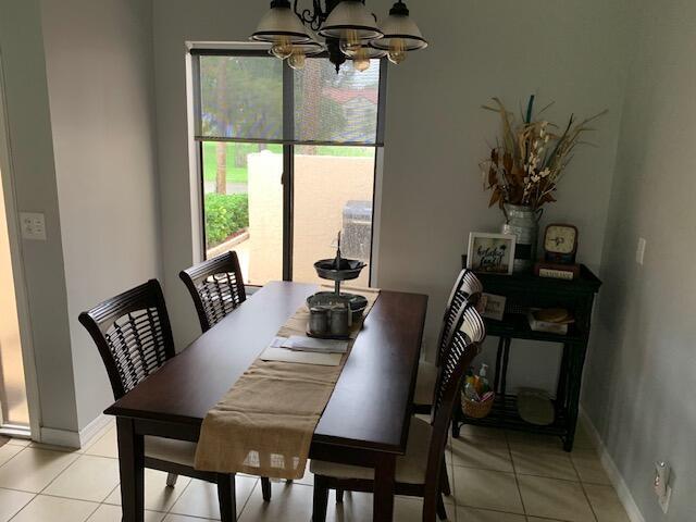 dining area with an inviting chandelier and light tile patterned floors