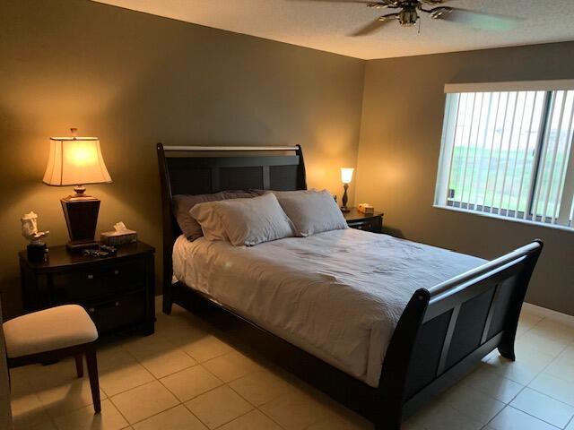 bedroom with light tile patterned flooring and ceiling fan