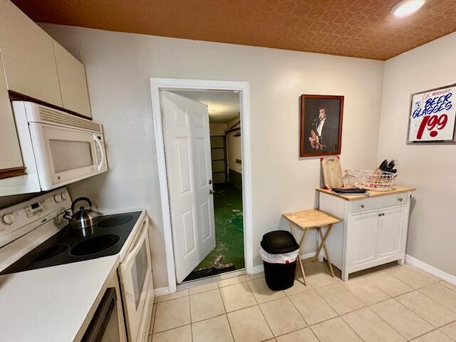 kitchen with light tile patterned floors and white appliances