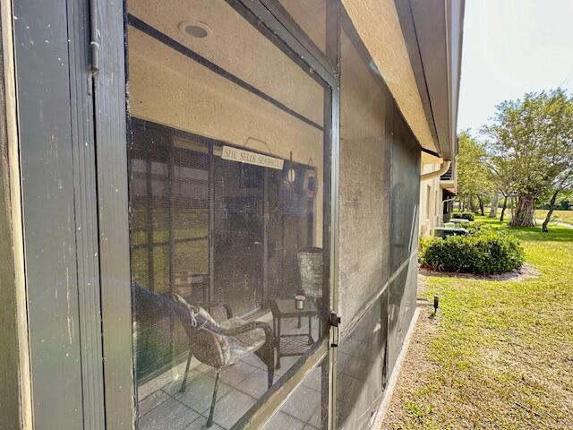 view of side of home with a lawn