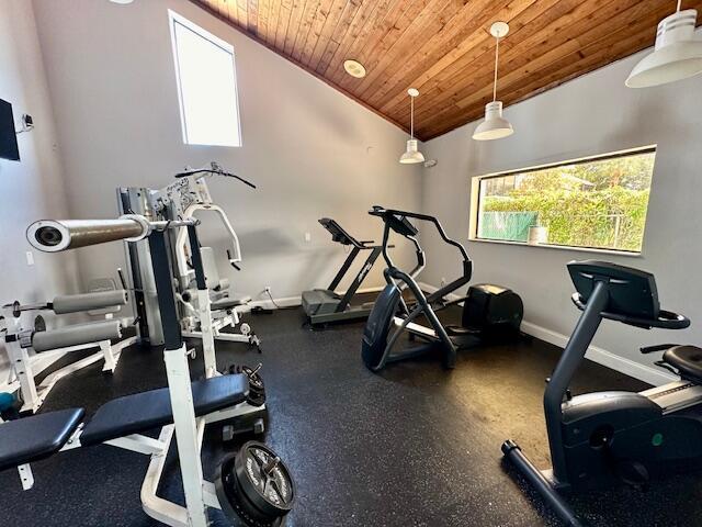 workout room featuring lofted ceiling and wooden ceiling