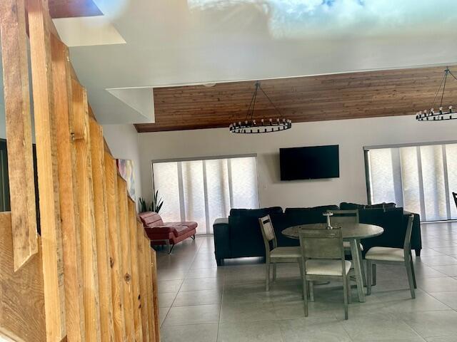 dining area with tile patterned flooring and wood ceiling