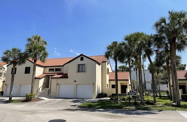 mediterranean / spanish home with a garage