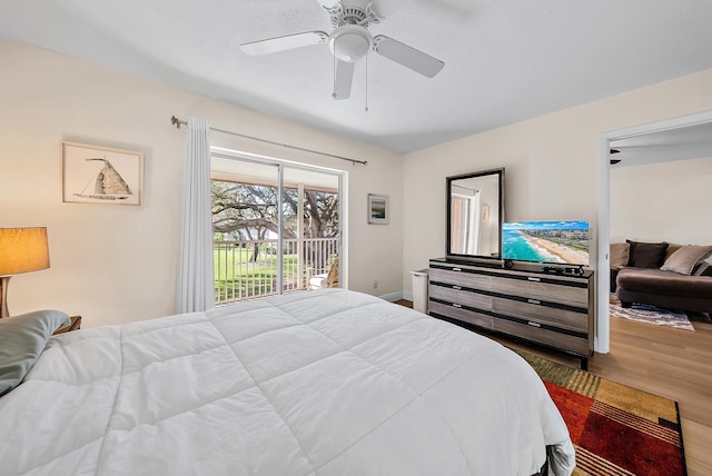 bedroom featuring hardwood / wood-style flooring, access to outside, and ceiling fan