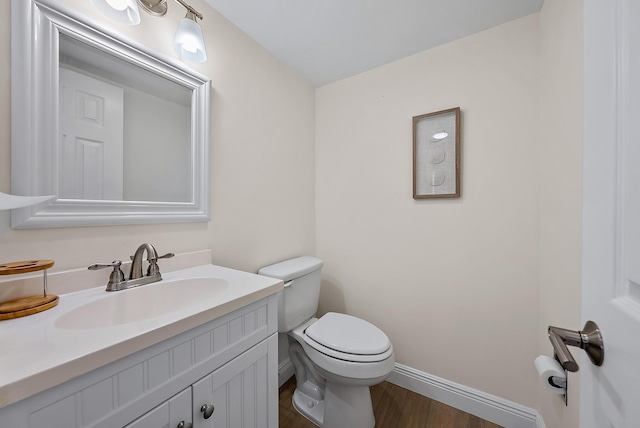 bathroom featuring hardwood / wood-style flooring, vanity, and toilet