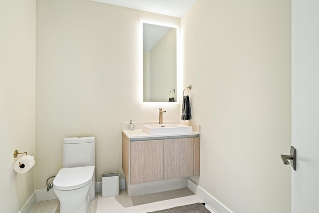 bathroom with tile patterned floors, vanity, and toilet